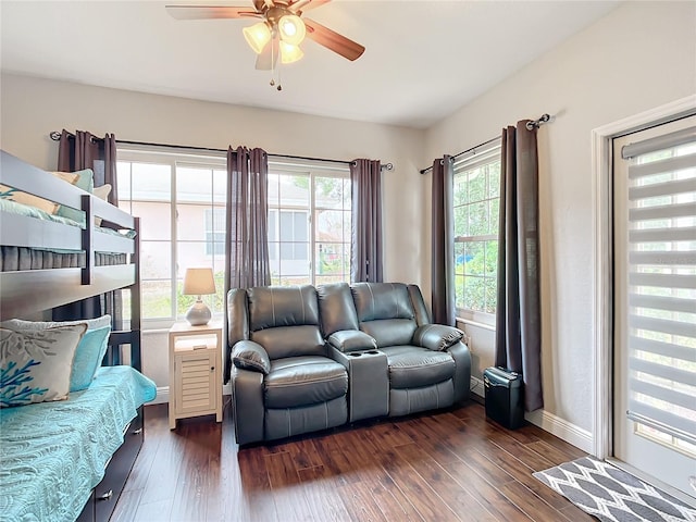 living room with dark wood-type flooring and ceiling fan