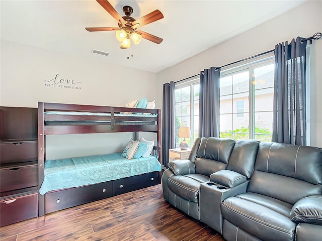 bedroom with dark hardwood / wood-style floors and ceiling fan