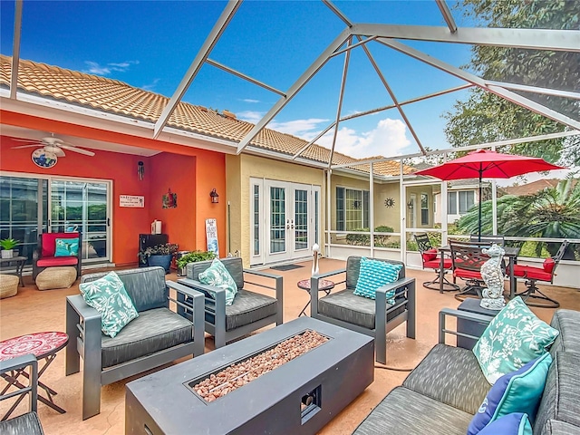 view of patio / terrace with french doors and an outdoor living space with a fire pit