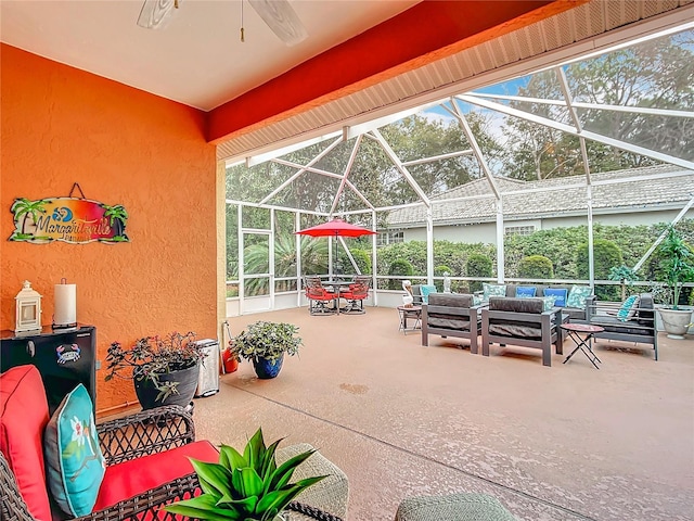 view of patio / terrace with ceiling fan, outdoor lounge area, and glass enclosure