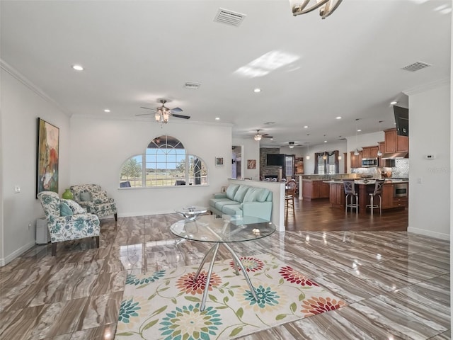 living room with crown molding and ceiling fan