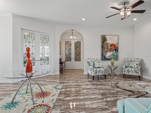 foyer entrance with ornamental molding, french doors, and ceiling fan