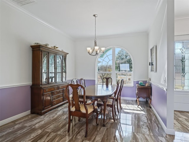 dining room with crown molding and an inviting chandelier