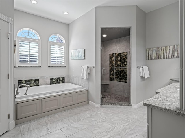 bathroom featuring vanity and shower with separate bathtub