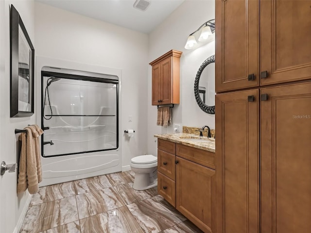 full bathroom featuring vanity, toilet, and combined bath / shower with glass door