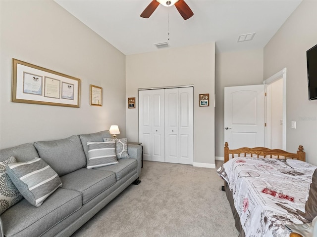 carpeted bedroom featuring ceiling fan and a closet