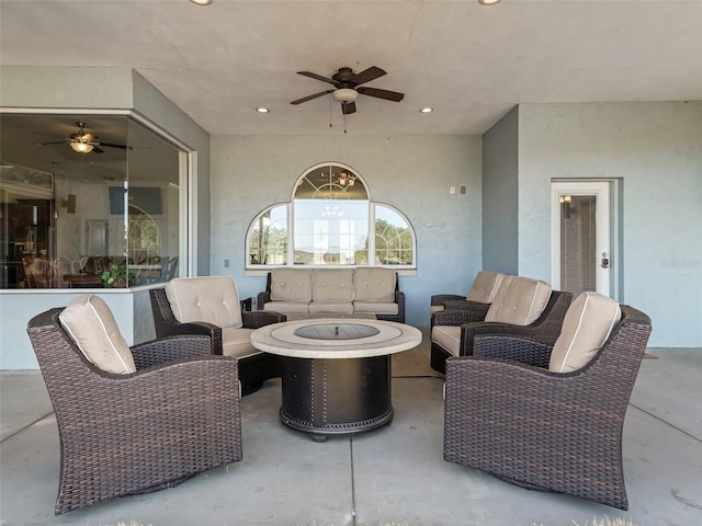 view of patio with an outdoor living space with a fire pit and ceiling fan