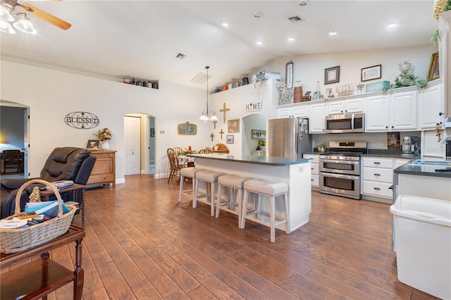 kitchen featuring sink, white cabinetry, a center island, pendant lighting, and stainless steel appliances