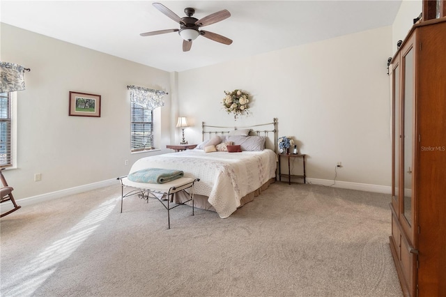 carpeted bedroom featuring a barn door and ceiling fan