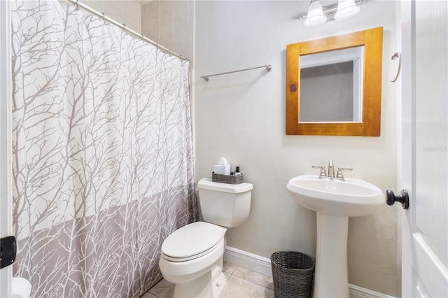 bathroom featuring sink, tile patterned floors, toilet, and walk in shower