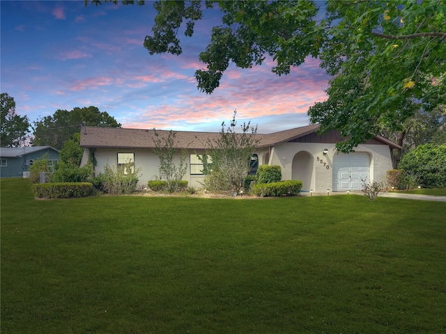 5570 W Cagney Loop, Homosassa, FL 34448 - single story home featuring a front yard, a garage, and stucco siding