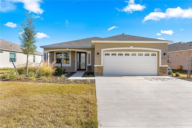 view of front of property with a garage and a front lawn