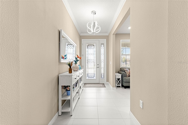 foyer featuring an inviting chandelier, light tile patterned floors, and crown molding