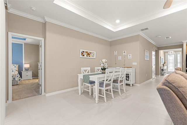 dining space featuring ornamental molding and a tray ceiling