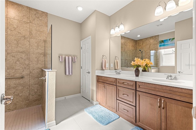 bathroom with vanity, tile patterned floors, and tiled shower