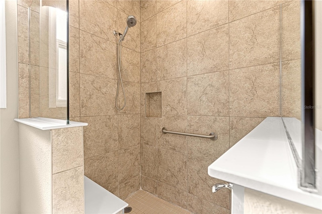 bathroom with a tile shower