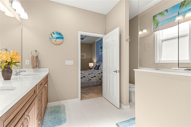 bathroom with vanity, tile patterned flooring, and toilet