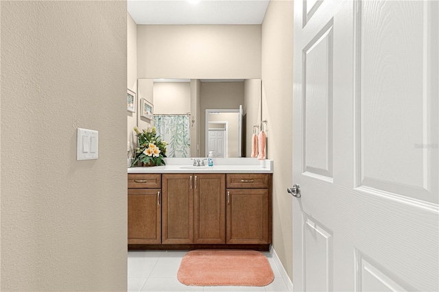 bathroom with tile patterned flooring, vanity, and curtained shower