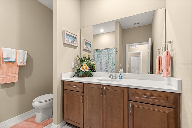 bathroom with a shower with shower curtain, vanity, toilet, and tile patterned flooring