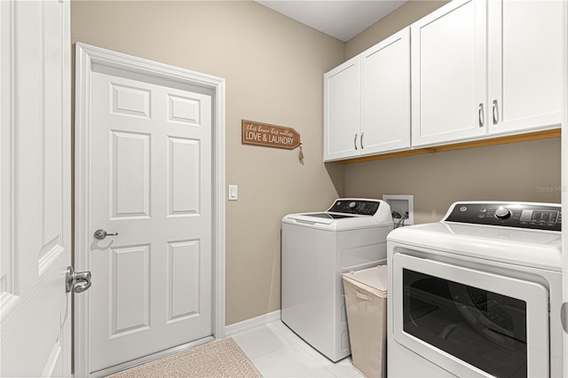 clothes washing area with cabinets, separate washer and dryer, and light tile patterned floors