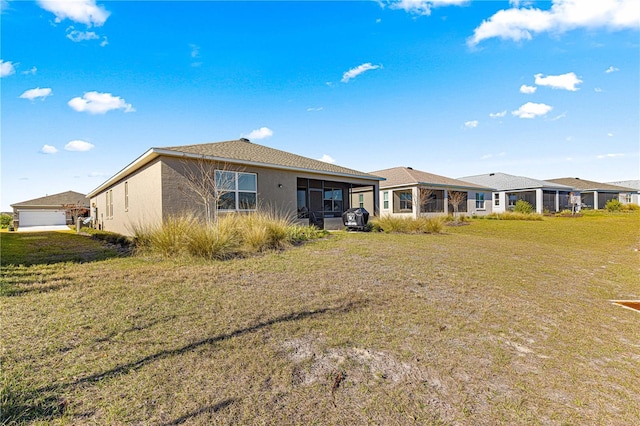 rear view of house featuring a yard