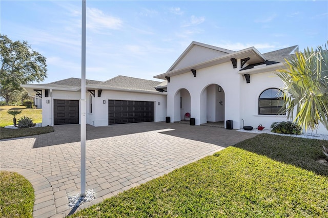 view of front of property with a garage and a front yard