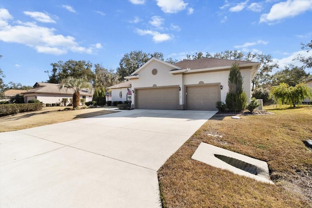 view of front of house with a garage and a front lawn