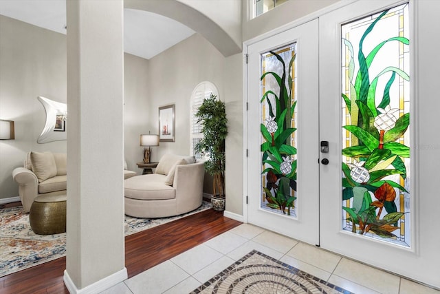 foyer entrance with french doors and light tile patterned flooring