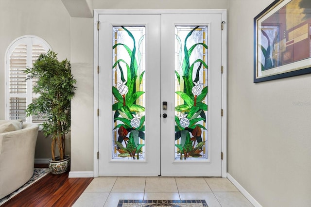 doorway to outside featuring light tile patterned flooring and french doors