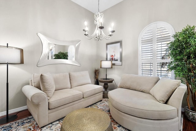 living room featuring lofted ceiling, hardwood / wood-style floors, and a notable chandelier