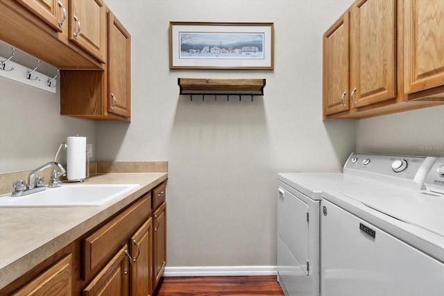 laundry area with sink, washer and clothes dryer, and cabinets