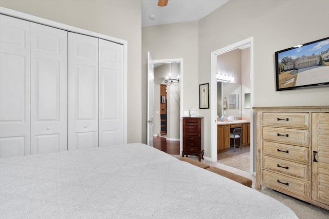 carpeted bedroom with a closet, ceiling fan, and ensuite bathroom