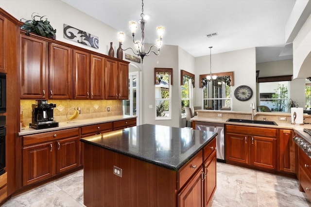 kitchen with decorative light fixtures, sink, a chandelier, a center island, and stainless steel dishwasher