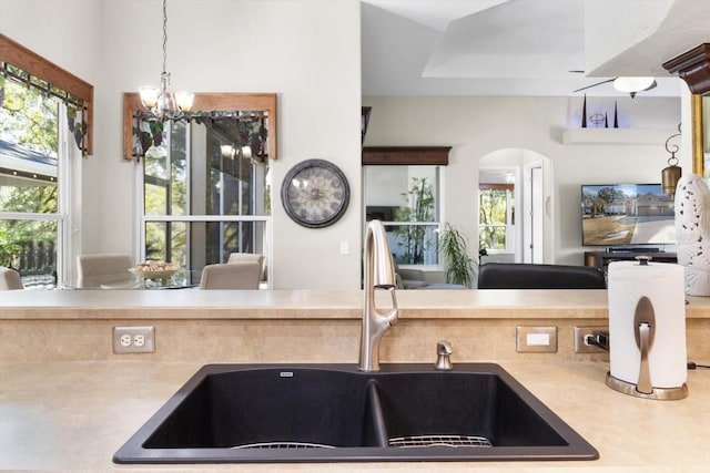 kitchen featuring sink, decorative light fixtures, and a notable chandelier