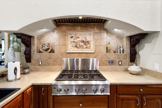 kitchen featuring tasteful backsplash, stainless steel gas stovetop, and sink