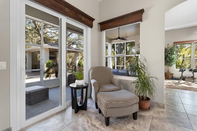 sunroom / solarium featuring ceiling fan