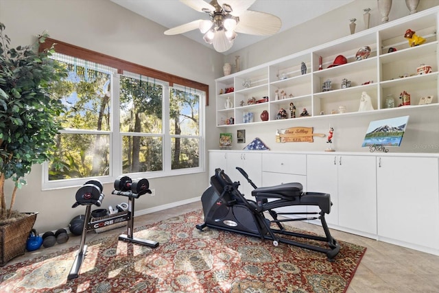 workout room featuring plenty of natural light, light tile patterned floors, and ceiling fan