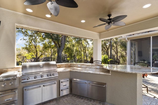 view of patio / terrace with ceiling fan, area for grilling, and a grill