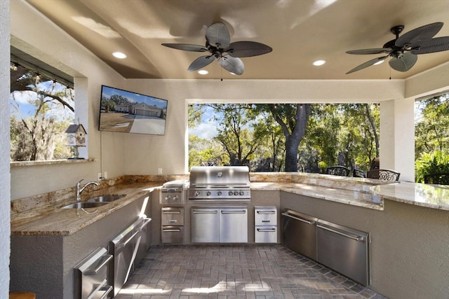 view of patio featuring a grill, area for grilling, sink, and ceiling fan