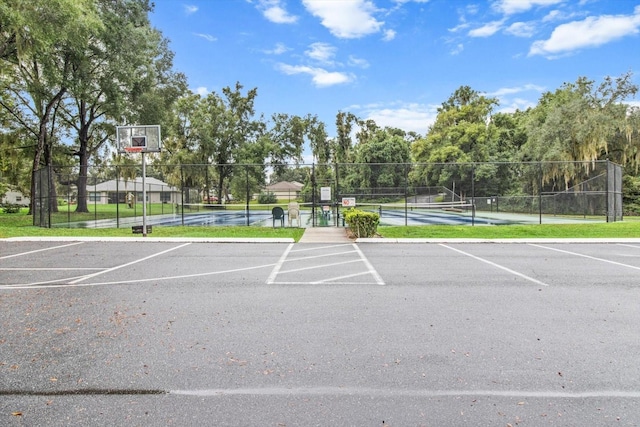 view of parking featuring tennis court