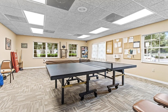 game room with light colored carpet, a paneled ceiling, and a wealth of natural light