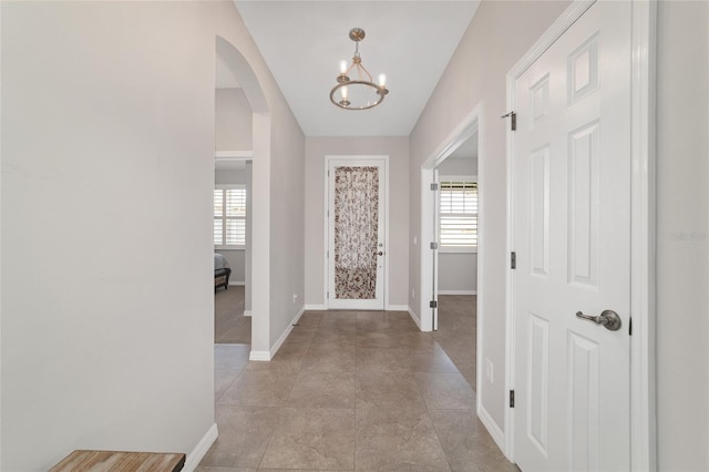 entrance foyer featuring an inviting chandelier and a healthy amount of sunlight