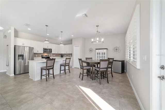 dining space featuring sink and a chandelier