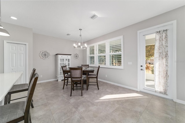 dining space with an inviting chandelier