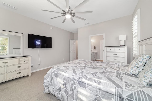 carpeted bedroom featuring ensuite bath and ceiling fan