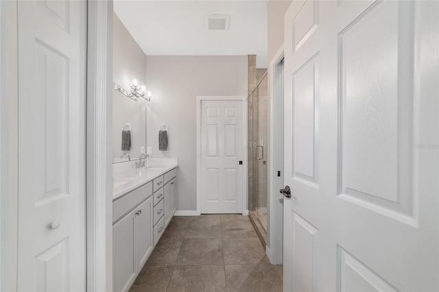 bathroom featuring vanity and a shower with shower door