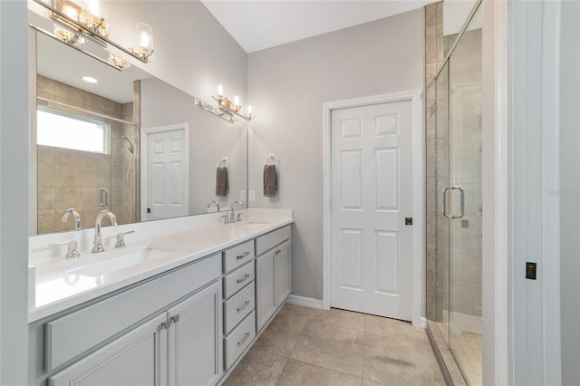 bathroom with tile patterned flooring, vanity, and an enclosed shower