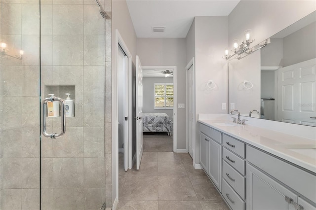 bathroom with vanity, an enclosed shower, and tile patterned floors