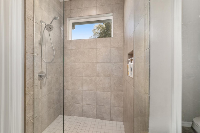 bathroom with toilet and tiled shower