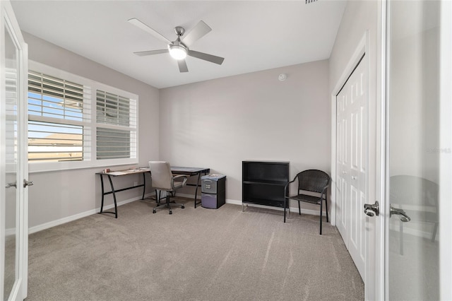 carpeted home office featuring ceiling fan and french doors